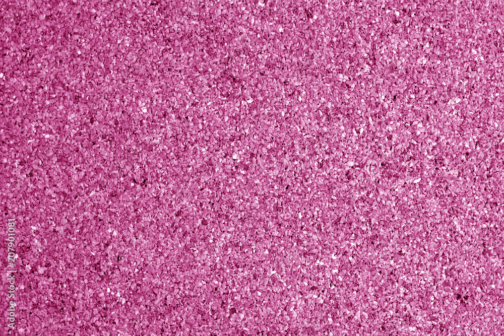 Cork board surface in pink tone.