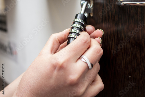 Female hands open the lock