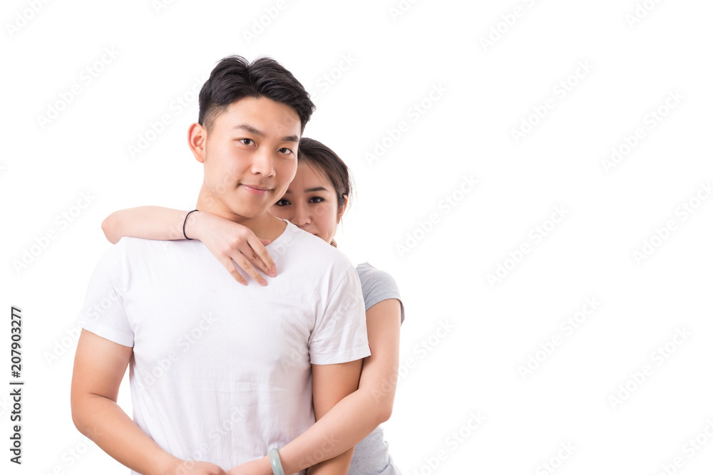 Happy young couple. Young woman standing behind her boyfriend Happy young couple. Young woman standing behind her boyfriend