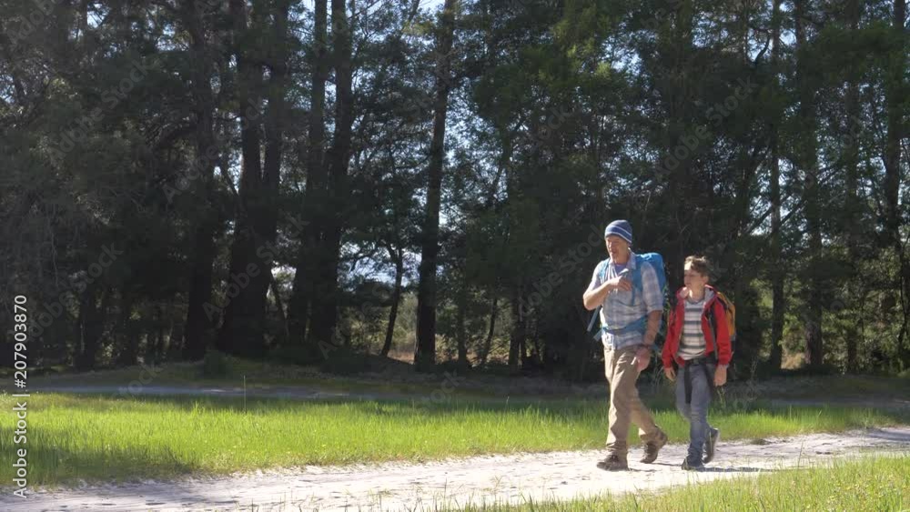Father and son hiking together in nature Father and son hiking together in nature
