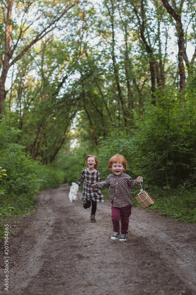 Children run along the forest road Children run along the forest road