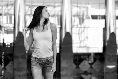 young girl in jeans posing outdoors