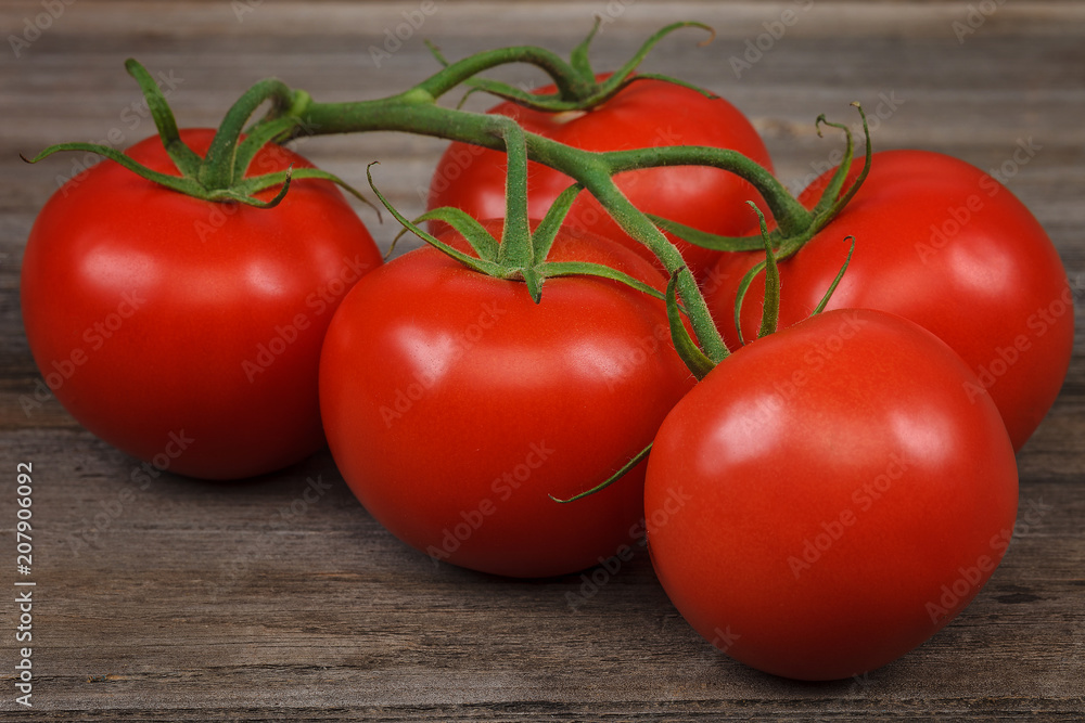 Branch fresh red tomato on wooden background Branch fresh red tomato on wooden background
