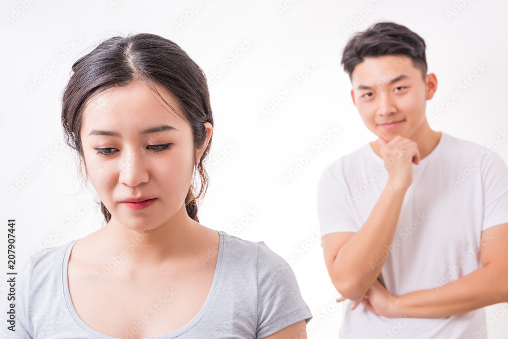 Couple in trouble. Young man looking at her girlfriend with a sly smile. Couple in trouble. Young man looking at her girlfriend with a sly smile.