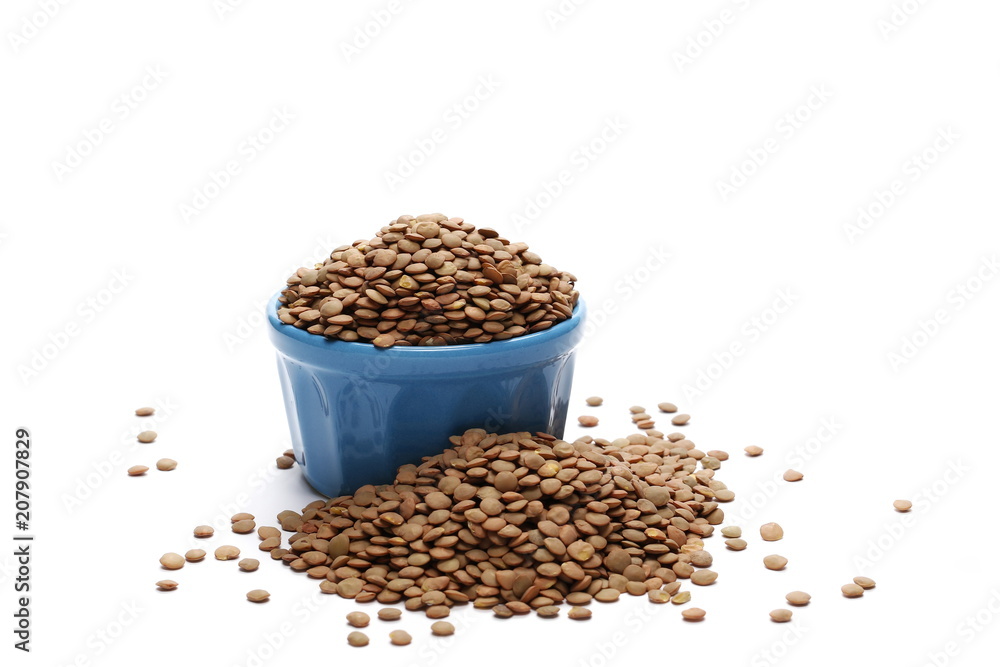 Pile of green lentils in blue porcelain bowl isolated on white background Pile of green lentils in blue porcelain bowl isolated on white background