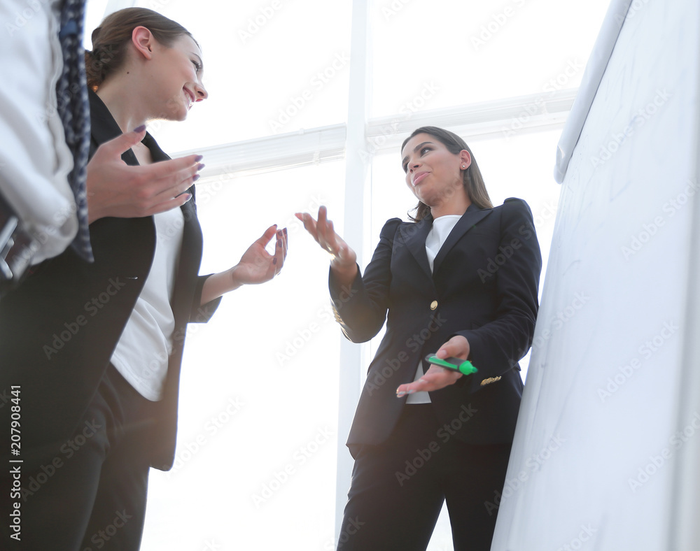 business woman pointing with a marker on the flipchart business woman pointing with a marker on the flipchart