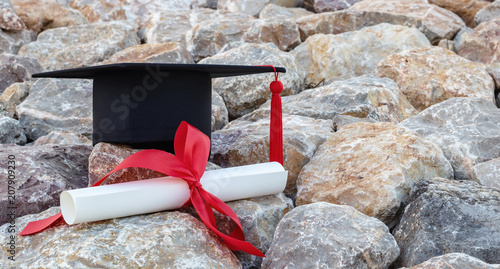 graduate hat and certificated in the rock garden. photo