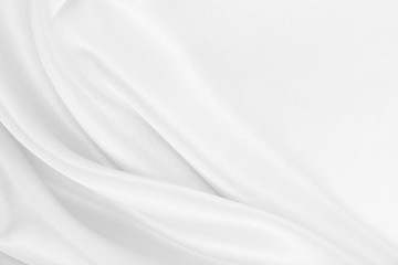 Smooth elegant white silk or satin luxury cloth texture as wedding background. Luxurious Christmas background or New Year background design