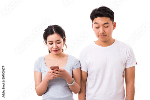 Curious man peeking message of his girlfriend on smartphone.