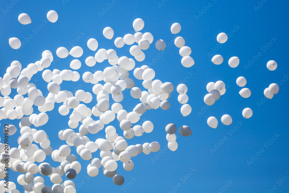 White balls flying in the blue sky White balls flying in the blue sky