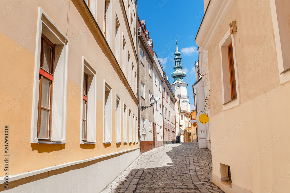 Traditional architecture building St. Michael tower and narrow street at foreground in Bratislava, Slovakia