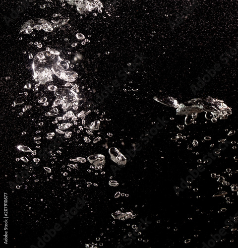 Bubbles of air in water on a black background