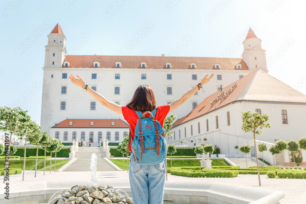 Young happy female tourist in Bratislava city near Castle or Hrad. Travel in Slovakia and Europe Union concept
