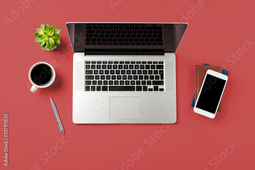Overhead shot of office desktop with modern laptop and accessories