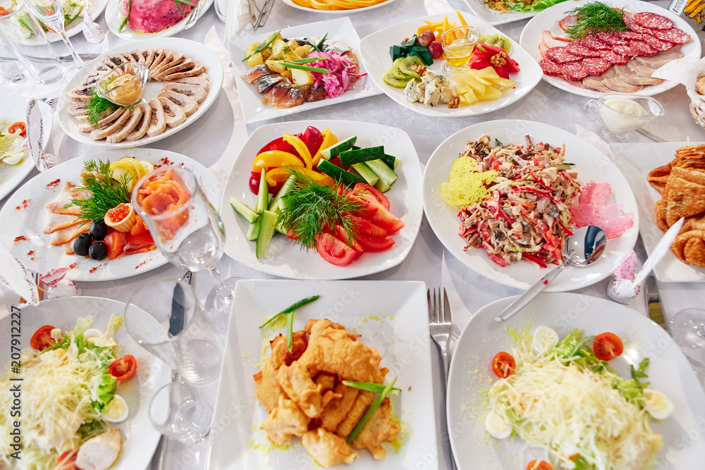 Beautifully decorated catering banquet table with different food snacks and appetizers on corporate, christmas, birthday, party event or wedding celebration Beautifully decorated catering banquet table with different food snacks and appetizers on corporate, christmas, birthday, party event or wedding celebration