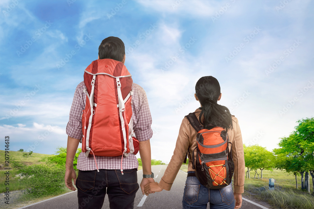 Romantic asian tourist couple holding hands and walking Romantic asian tourist couple holding hands and walking