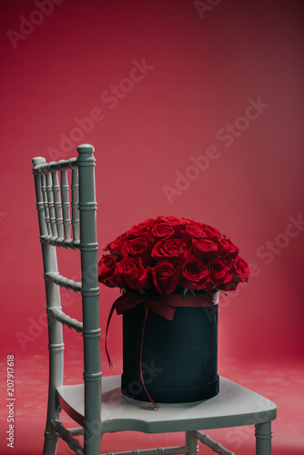 Romantic red roses in a gift textured black box to place the logo on a black background studio,spring is coming,international women's day