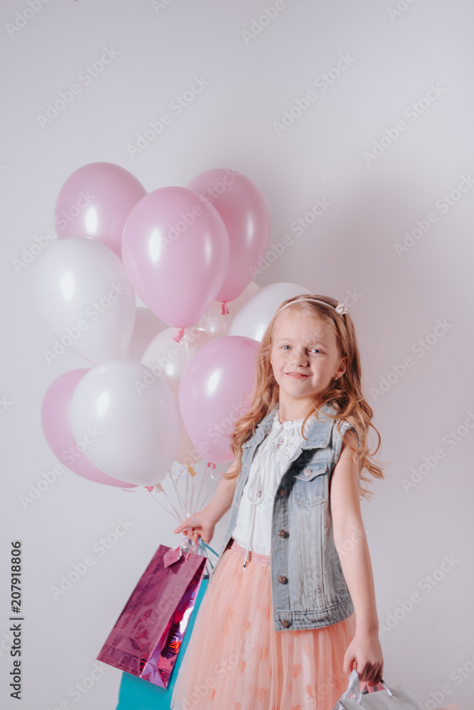 happy little girl celebrating birthday with balloons and gifts.joyful child girl on birthday party happy little girl celebrating birthday with balloons and gifts.joyful child girl on birthday party