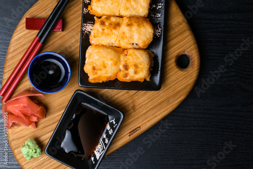 Hot fried Sushi Roll with salmon, caviar, shrimp, cucumber, avokado, cheese. Sushi menu. Japanese food. Hot fried Sushi Roll photo