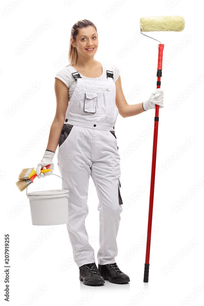 Female painter holding a paint roller and a color bucket Female painter holding a paint roller and a color bucket