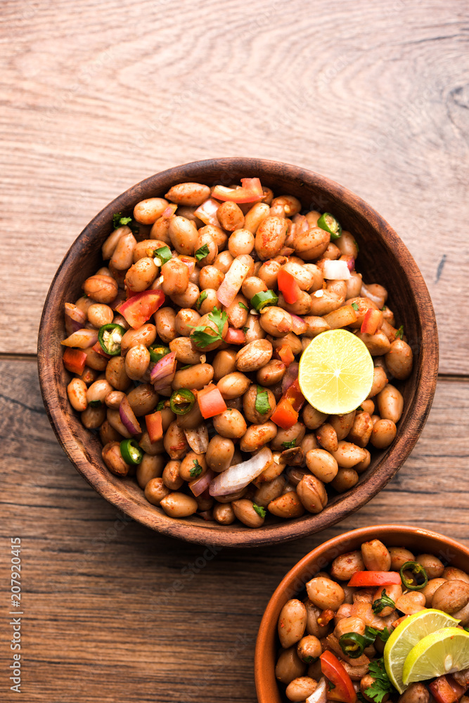 Boiled Peanut Chaat or Chatpata sing dana or shengdana or mungfali. served in a ceramic bowl over moody background Boiled Peanut Chaat or Chatpata sing dana or shengdana or mungfali. served in a ceramic bowl over moody background