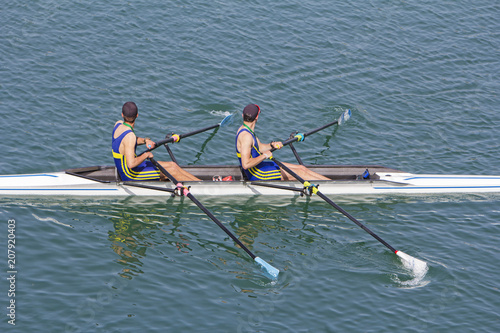 Two young rowers in a racing rower boat photo
