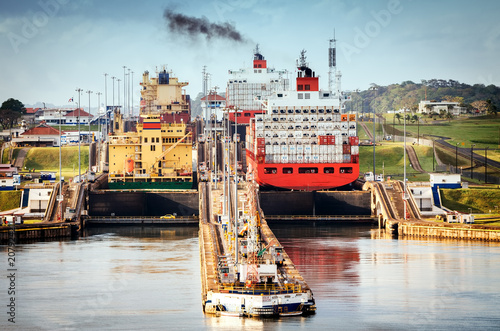 Panama City, Panama - February 20, 2015: A freighter entering the Canal locks of Miraflores in the Panama Canal, the Canal locks are at each end to lift ships up. photo