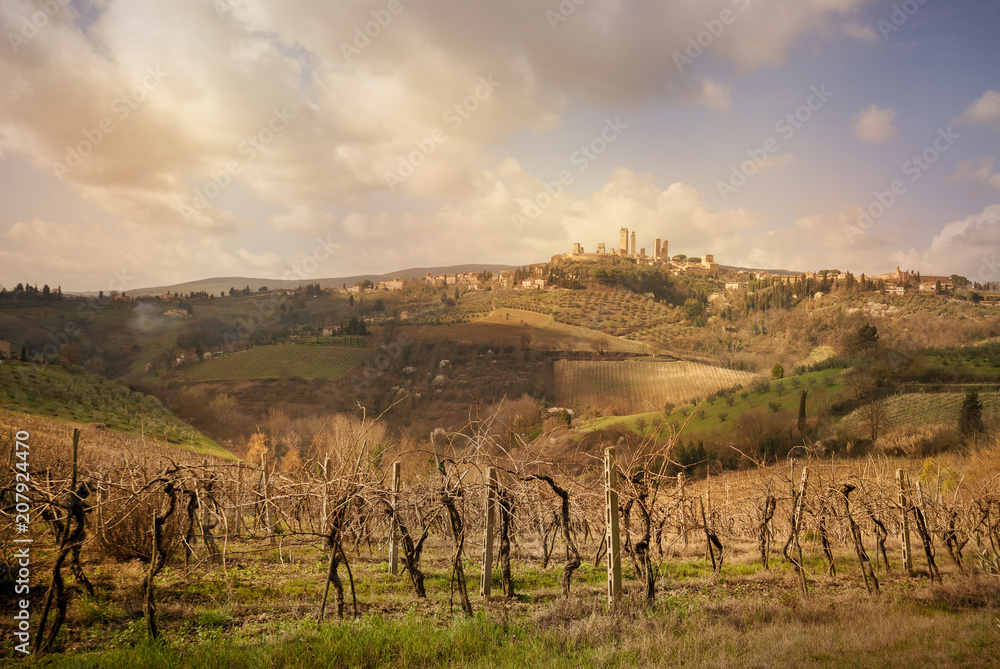 San Gimignano medieval town towers skyline and countryside landscape panorama at sunset. Siena, Tuscany, Italy.