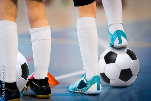 Indoor soccer players training with balls. Indoor soccer sports hall. Football futsal player, ball, futsal floor. Sports background. Futsal league. Indoor football players with classic soccer ball.