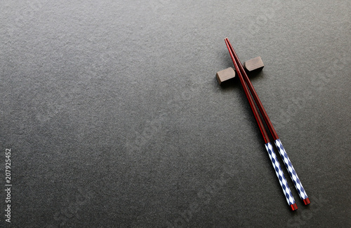 wooden Chopsticks on blackboard Japanese and Chinese food equipment.Top view with copy space