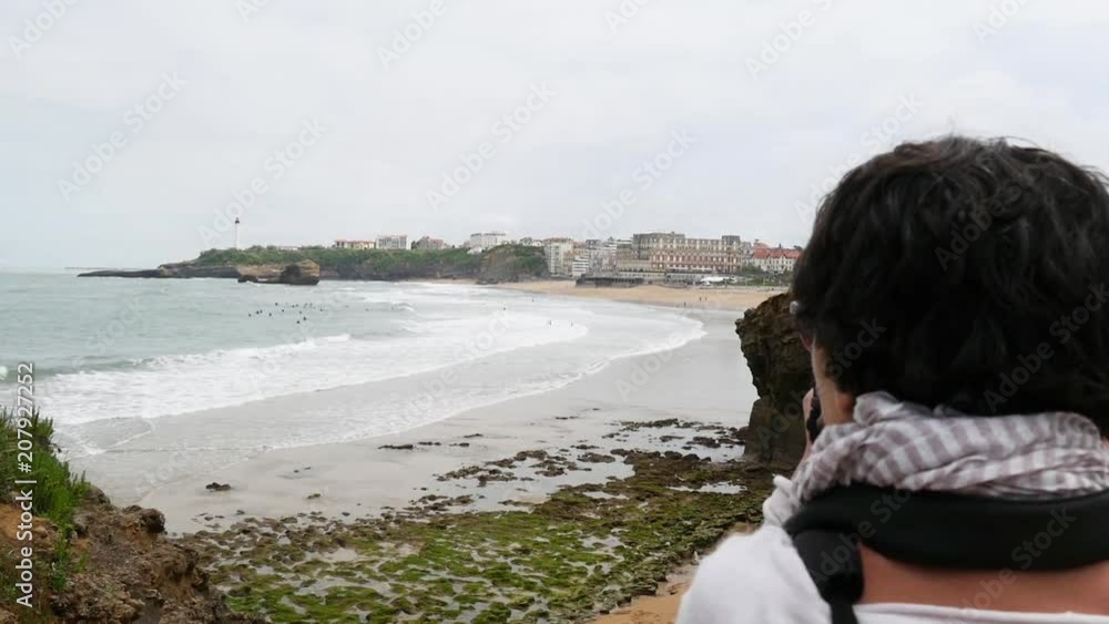 woman photographer taking picture of Biarritz beach woman photographer taking picture of Biarritz beach