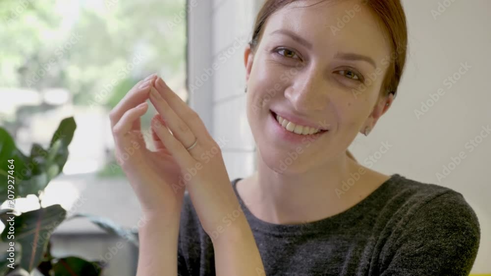 Portrait of young beautiful woman with ponytail sitting in cafe and looking in camera, smiling Portrait of young beautiful woman with ponytail sitting in cafe and looking in camera, smiling