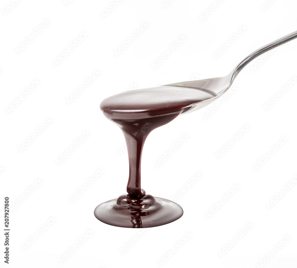 Fototapeta premium chocolate syrup pouring on spoon, cooking, baking