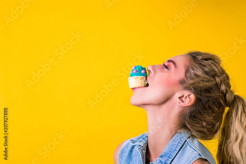 Slika na platnu funny girl passionately bites tasty cupcake