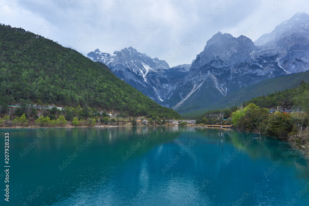Beautiful view of Blue Moon Valley in Jade Dragon Snow Mountain reflected in clear water. It's in Lijiang, Yunnan, China 