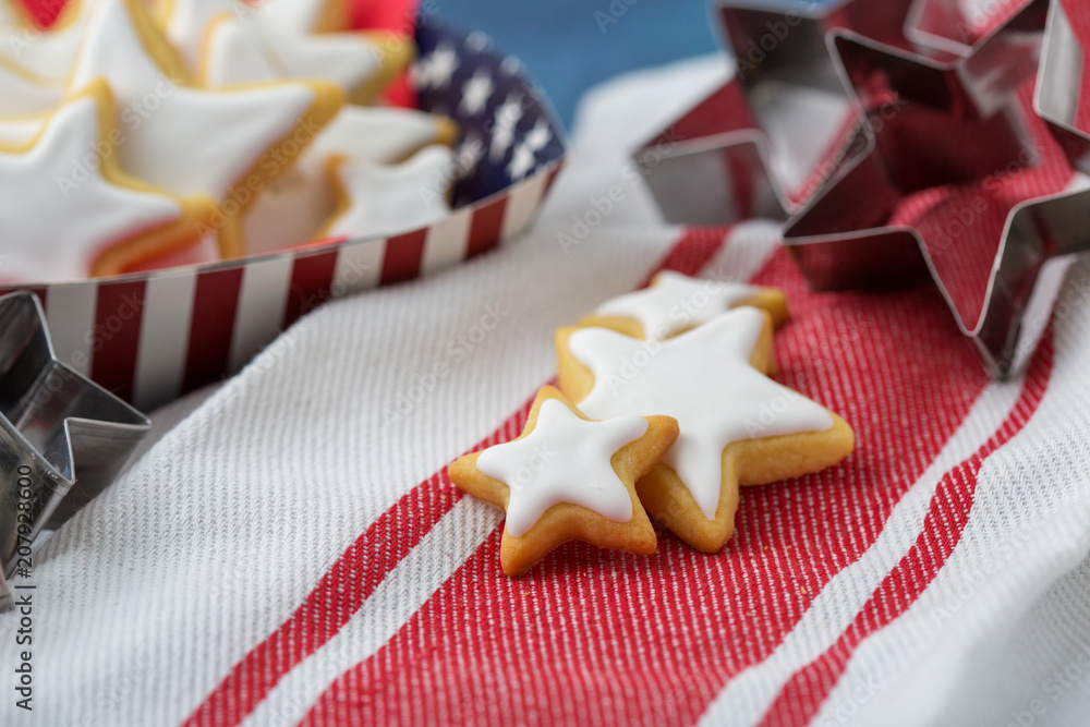 Homemade Star Shaped Sugar Cookies Served in Red, White, and Blue Paper Products against a Blue Background Homemade Star Shaped Sugar Cookies Served in Red, White, and Blue Paper Products against a Blue Background