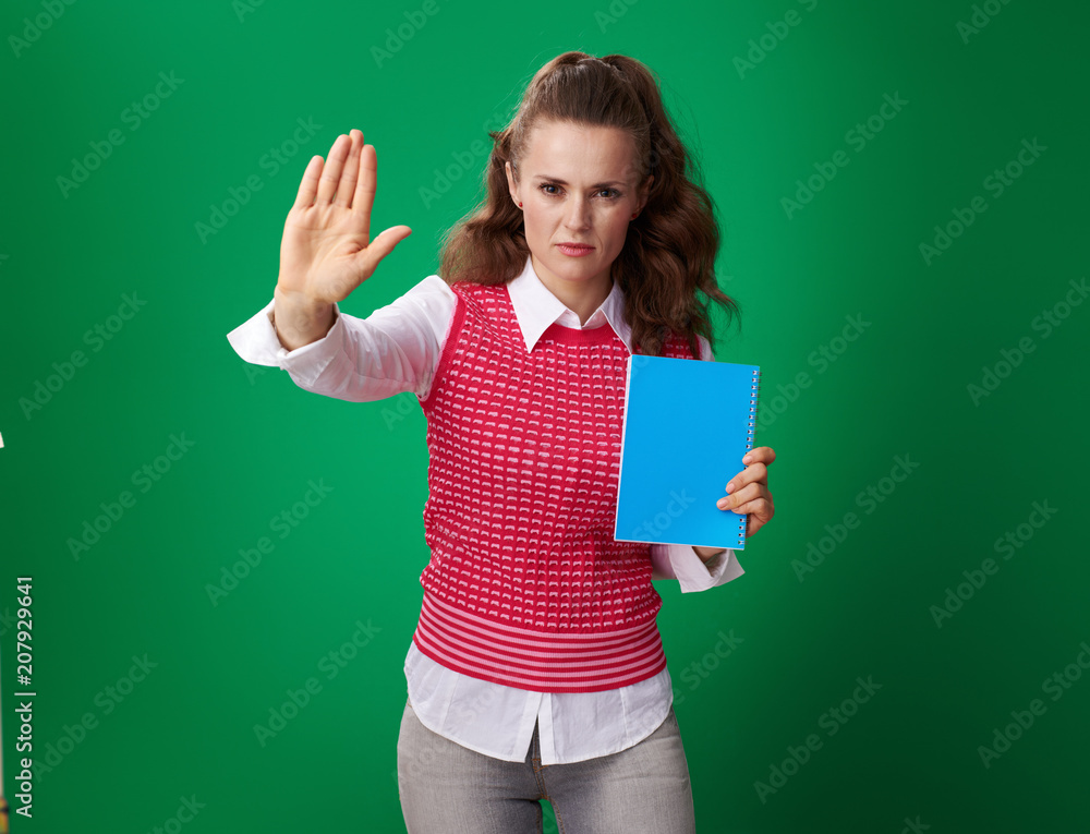 modern student woman with blue notebook showing stop gesture modern student woman with blue notebook showing stop gesture