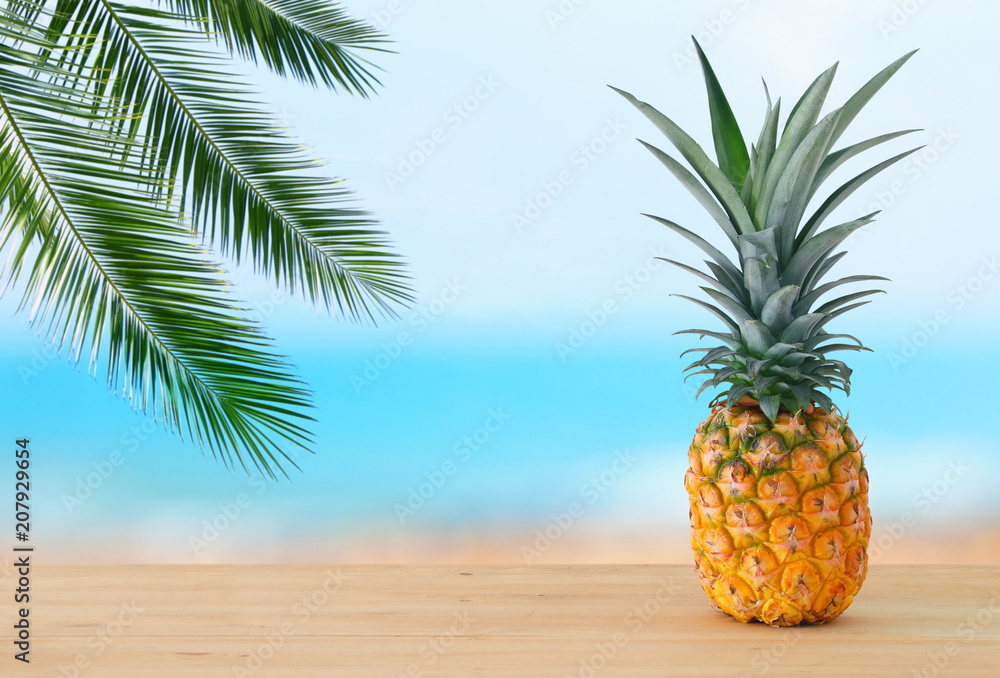 Pineapple on wooden table. Beach and tropical theme. Pineapple on wooden table. Beach and tropical theme.