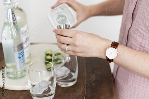 Woman measuring out spirts for cocktail