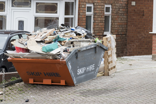 Street side skip filled with rubish photo
