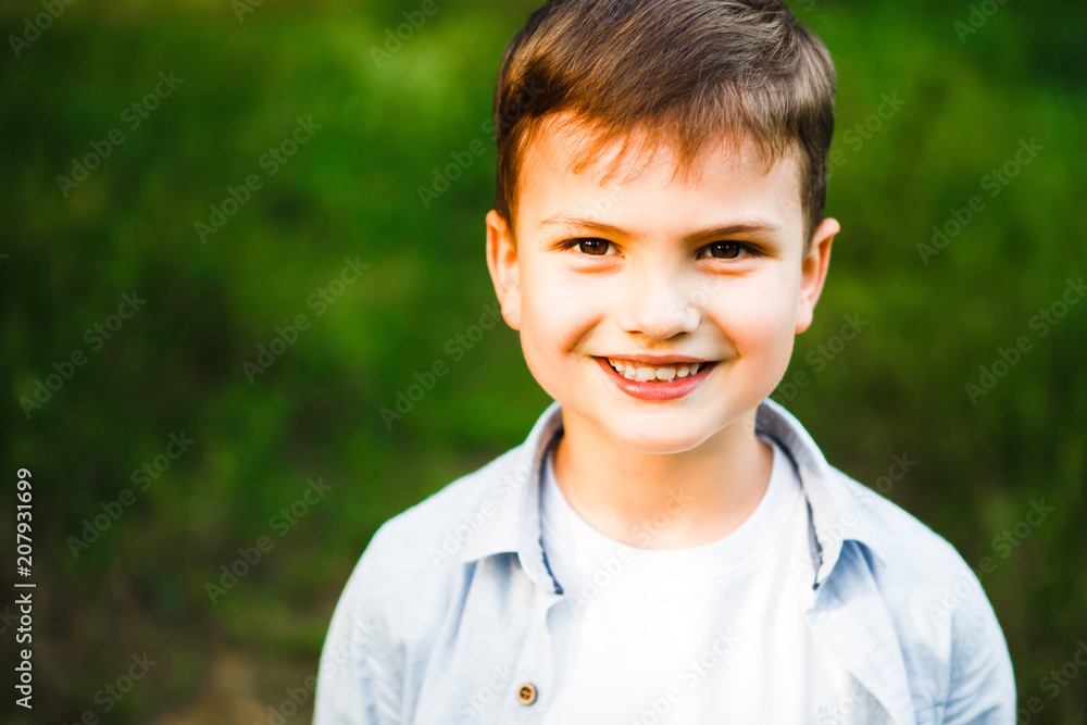 A beautiful European boy is smiling and looking at the camera. A beautiful European boy is smiling and looking at the camera.