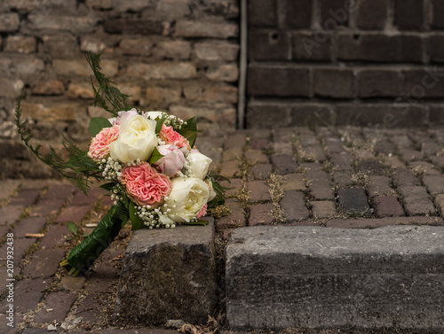 brides bouquet or wedding flowers on a street photo