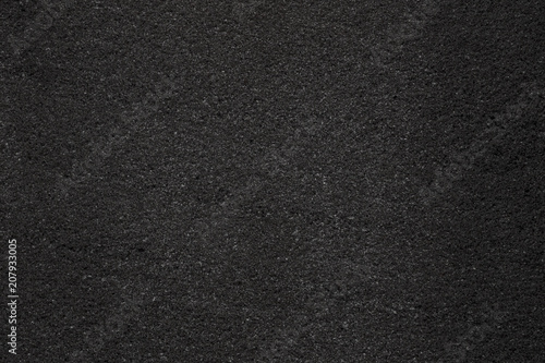 Asphalt with fine grain texture. Close-up of black road background. Top view of the rough surface