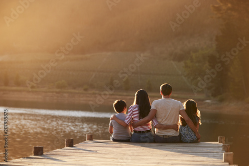 Rear View Of Family Standing On Wooden Jetty By Lake © Monkey Business
