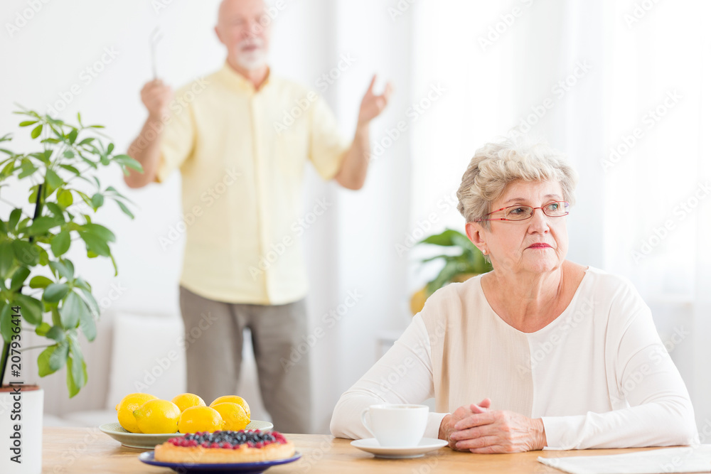 Sad senior woman arguing with her husband Sad senior woman arguing with her husband