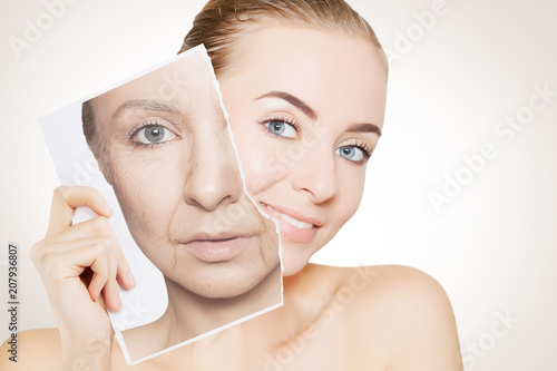 portrait of young woman face holding portrait with old wrinkled face