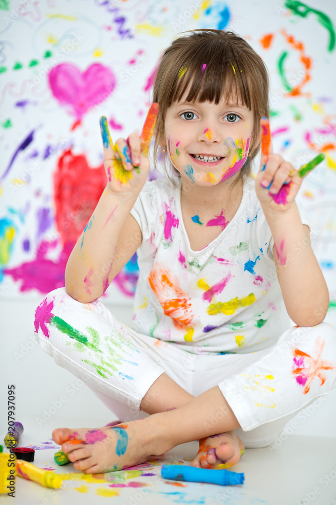 Portrait of a cute cheerful happy little girl showing her hands painted ...