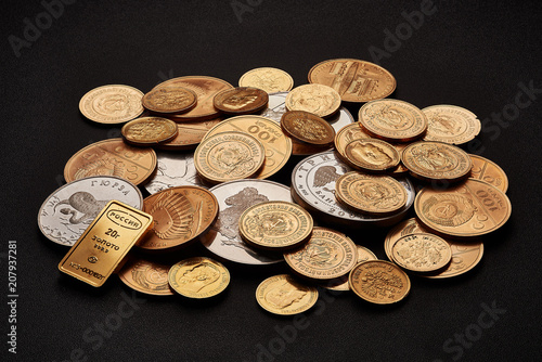 White and yellow gold bars and coins isolated on black background