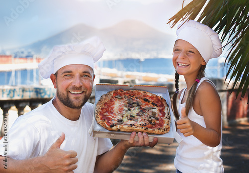 Cute dad with daughter holding pizza