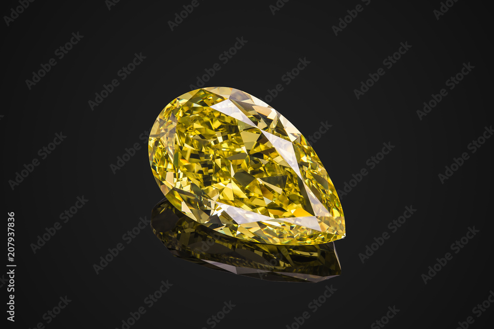 Luxury yellow transparent sparkling gemstone shape pear cut diamond isolated on black background Luxury yellow transparent sparkling gemstone shape pear cut diamond isolated on black background